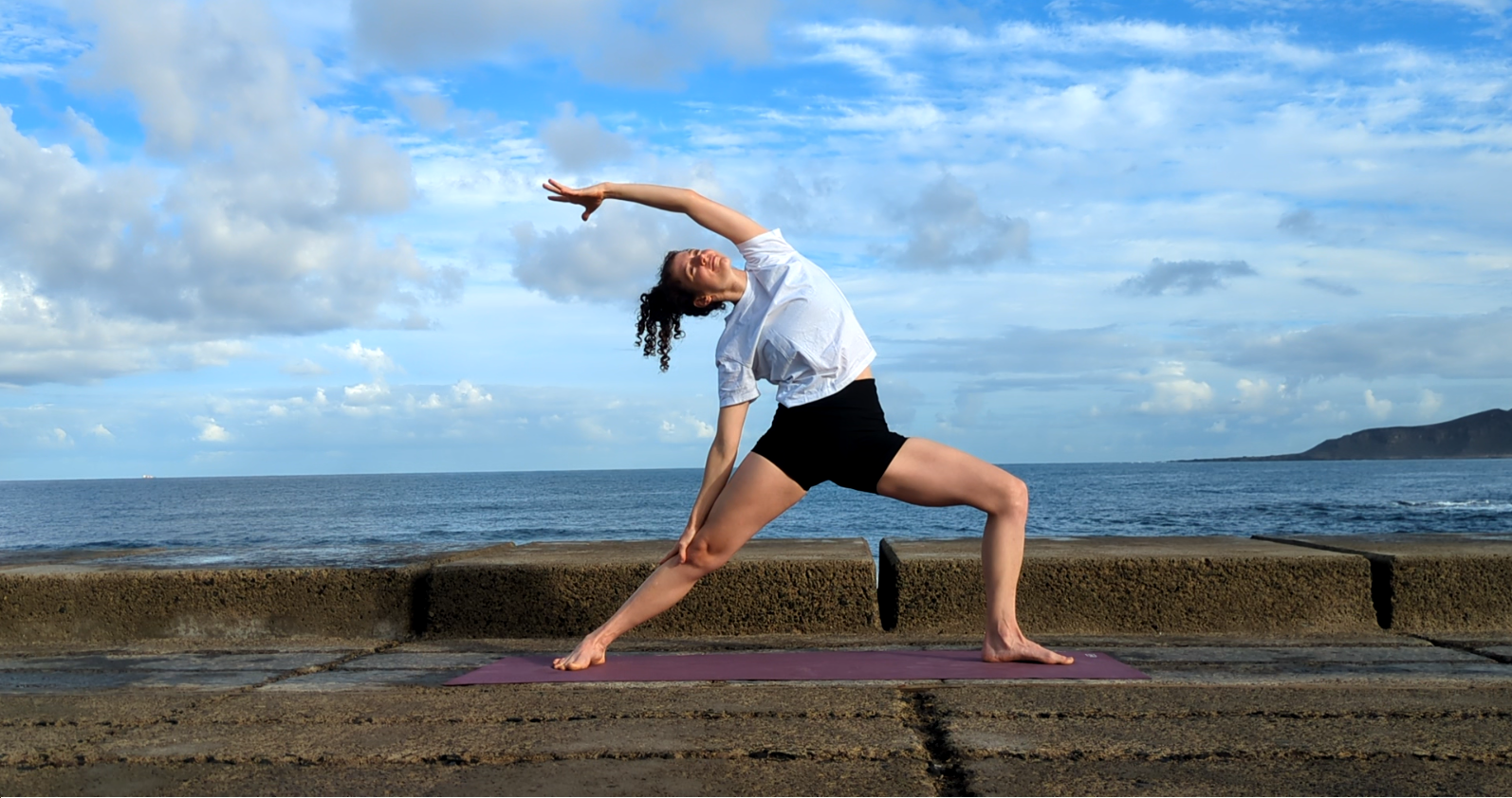 Jessica Wolf bei einer Yogaübung am Meer